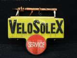 un panneau jaune sur lequel est inscrit « Velosolex Service »