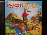 a board game called queendomino with a castle in the background