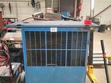 a blue air conditioner sitting in a garage