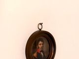 many portraits of people on the wall of this room