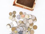 a small purse full of coins on a white surface