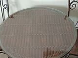 three chairs and a table with a glass top