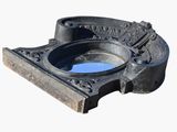 a picture of a cast iron ashtray with a blue glass in it