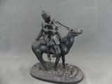 a statue of a man riding a horse with a woman on it