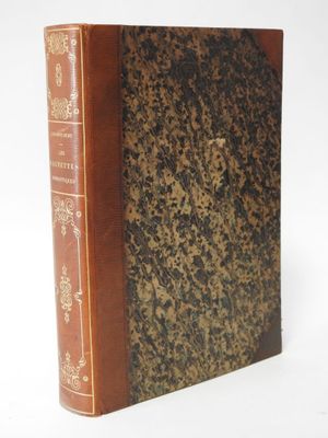 an old book sitting on top of a table next to a white background