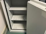 a small open cabinet in the corner of a room