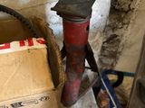 a box and a hammer sitting on the floor next to a fire hydrant