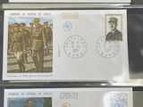 four stamps with military images are on display on a table