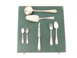 a green place mat with silverware and spoons on it