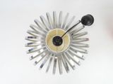 a clock that is on the wall next to a vase