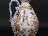a white and blue vase with a floral design on it