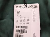the back of a green jacket with a price tag attached to it