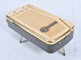 a gold and black cell phone sitting on a table