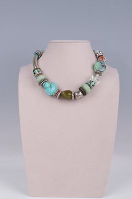 a close up of a necklace on a mannequin display