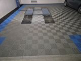 a car parked in a garage with a checkered floor
