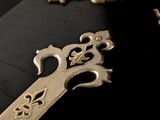 a close up of a cross on a black surface