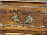 a wooden chest of drawers with ornate carvings on it
