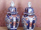 two blue and white vases sitting on a table