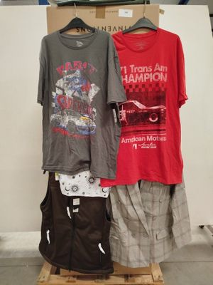 two shirts hanging on a rack in front of a white wall