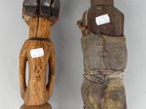 two carved wooden figurines of a man and a woman