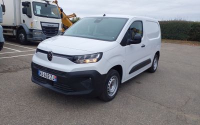 a white van parked in a parking lot next to a truck