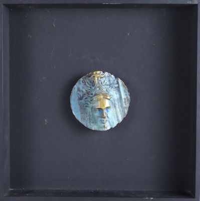 a black shadow box with a blue face in it