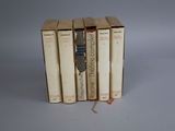 three books are stacked on top of each other on a table