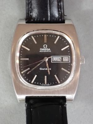 a silver watch with a black face on a black leather strap