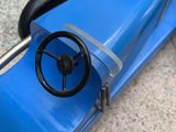 an image of a blue toy car sitting on top of a floor