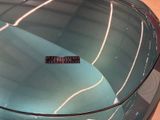 a close up of a car ' s hood with a sticker on it