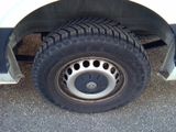 a close up of a tire on a white truck