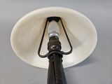 a lamp that has a black handle on it