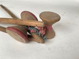 a pair of wooden knitting needles and a pair of wooden knitting needles on a white surface