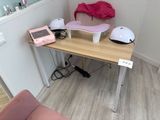 a desk with a phone, helmet, and other items on it
