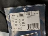 a label on the back of a jacket with a price tag attached to it