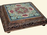 a small wooden box with a floral design on it