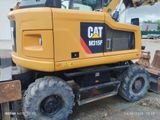 a picture of a yellow construction vehicle parked in a parking lot