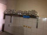 many glasses on a shelf in the kitchen