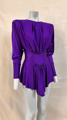 a mannequin wearing a purple top and white pants on a mannequin mannequin mannequin mannequin mannequin mannequin mann
