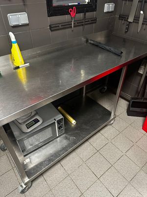 a metal work bench in a kitchen with a lot of tools on it