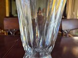 a glass vase sitting on a table in a room