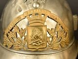 a silver helmet with a gold emblem on it