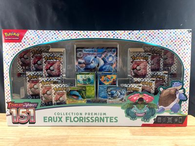 the box contains a collection of pokemon trading cards and collectibles