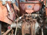 a rusted out tractor with a license plate on it