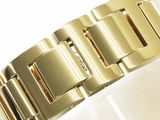 an image of a close up of a gold bracelet on a white surface