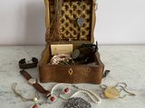a wooden box with a bunch of jewelry inside of it