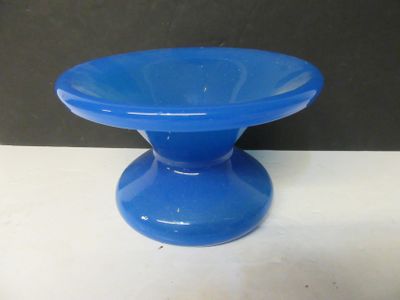 a blue glass bowl sitting on top of a white table