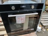 a black oven sitting on a pallet with a price tag on it