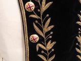 a close up of a black jacket with gold embroidery on it