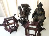 three asian figurines sitting on a white table